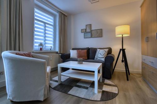 a living room with a couch and a table at Altstadt Domizil in Pirna