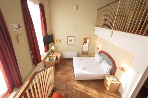 a living room with a white couch in a room at Hotel Belvedere San Gottardo by LVG Hotel Collection in Verbania