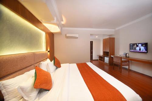 a hotel room with a bed and a television at Hotel Mums Home in Kathmandu
