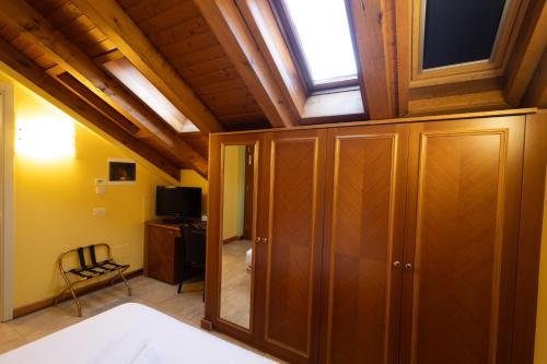 a bedroom with a skylight and a bed and a window at Hotel Belvedere San Gottardo by LVG Hotel Collection in Verbania