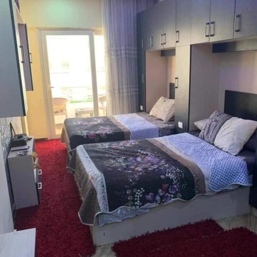 a hotel room with two beds and a window at Elite apartment private beach Holiday Chalet Free WIFI in Hurghada