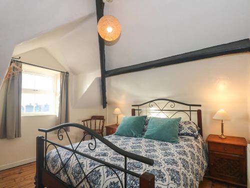 a bedroom with a bed with a wrought iron bed frame at Rose Hill in Barmouth