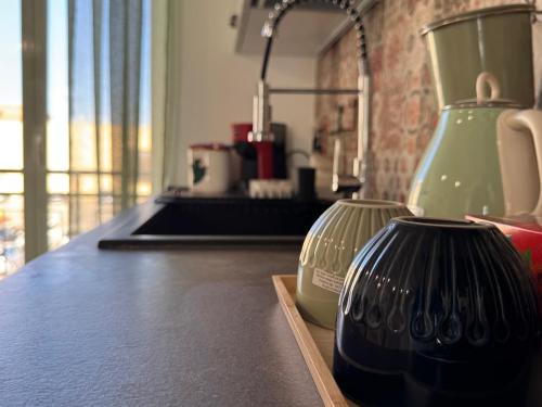 two glass vases sitting on a counter in a kitchen at Casa Cibella Authentic Charme Apartments in Agrigento