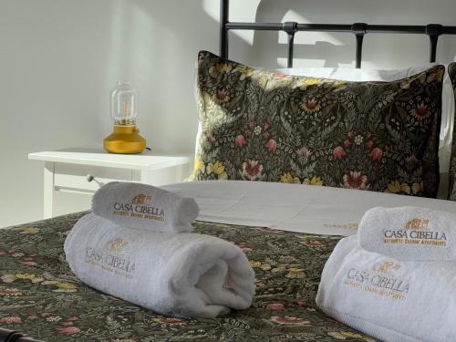 a bed with two towels on top of it at Casa Cibella Authentic Charme Apartments in Agrigento