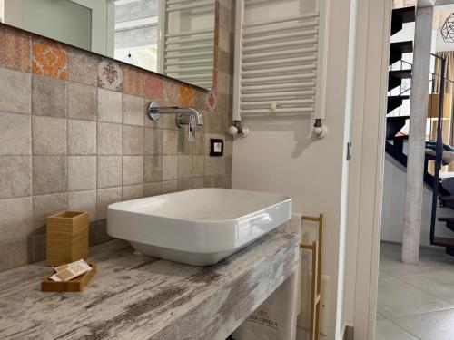 a bathroom with a large white sink on a counter at Casa Cibella Authentic Charme Apartments in Agrigento