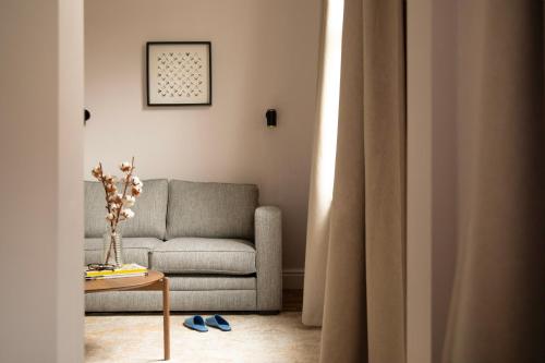 a living room with a couch and a table at Bob W London Olympia in London