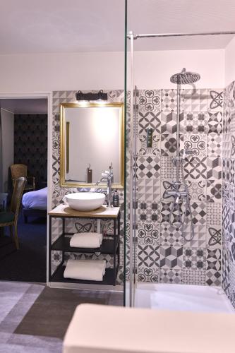 a bathroom with a sink and a shower at La Flambée in Sennecey-lès-Dijon