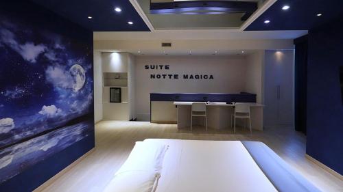 a bedroom with a bed and a desk in a room at Motel Soignè in Mapello