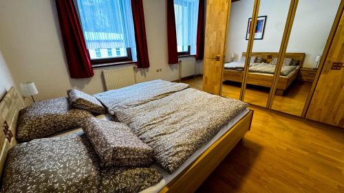 a bedroom with two beds and a mirror at House of BaRanGo in Präbichl
