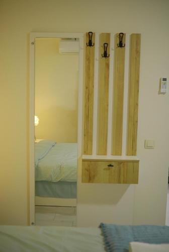a mirror in a room with a bed at City Center Apartment in Kakhaberi