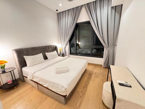 a bedroom with a large bed and a window at LUCENTIA RESIDENCE By LALAPORT in Kuala Lumpur