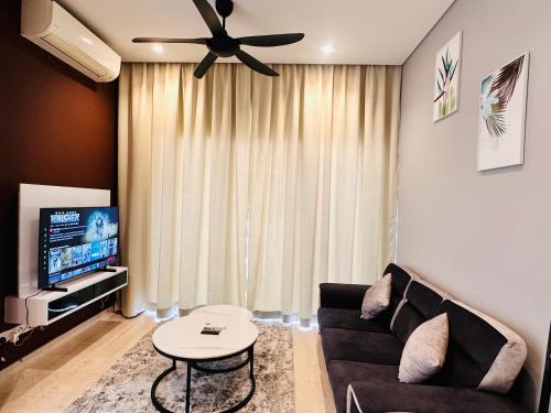 a living room with a couch and a ceiling fan at LUCENTIA RESIDENCE By LALAPORT in Kuala Lumpur