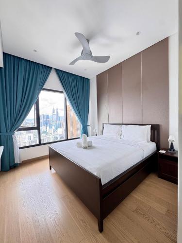 a bedroom with a large bed with a ceiling fan at LUCENTIA RESIDENCE By LALAPORT in Kuala Lumpur