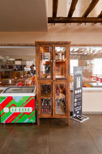 a wooden cabinet with drinks inside of a store at Meu Hotel Boituva in Boituva