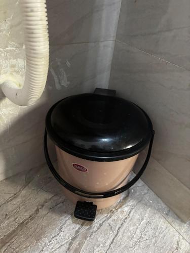 a pot with a black lid on top of it at Hireath! in Kelve Road