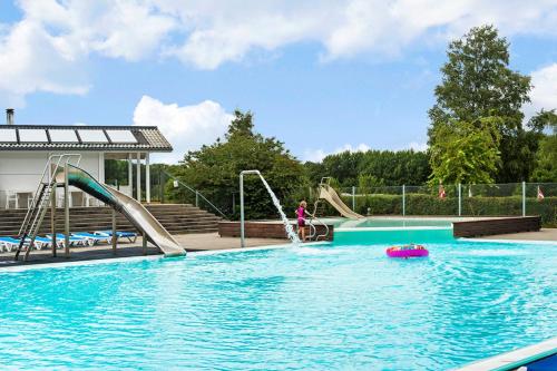a person is playing in a swimming pool at First Camp Frigård Camping & Cottages in Kruså