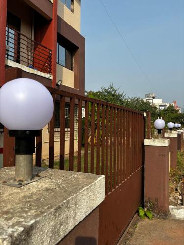 a fence with two lights on the side of a building at Hireath! in Kelve Road