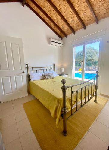 a bedroom with a bed and a large window at The Bungalow Kyrenia North Cyprus in Ayios Ioannis