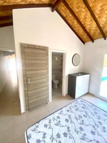 a bathroom with a sliding door and a toilet at The Bungalow Kyrenia North Cyprus in Ayios Ioannis