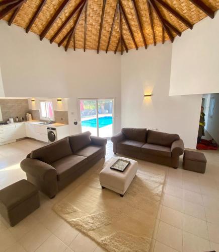 a living room with two couches and a table at The Bungalow Kyrenia North Cyprus in Ayios Ioannis