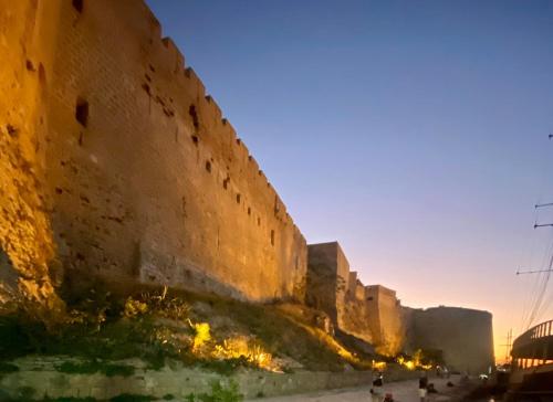 a large brick wall with people standing next to it at The Bungalow Kyrenia North Cyprus in Ayios Ioannis