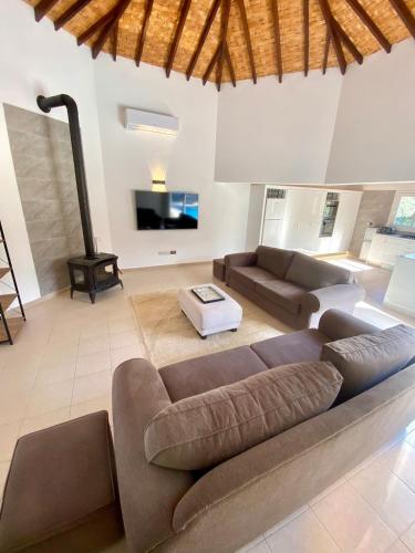 a large living room with a couch and a tv at The Bungalow Kyrenia North Cyprus in Ayios Ioannis