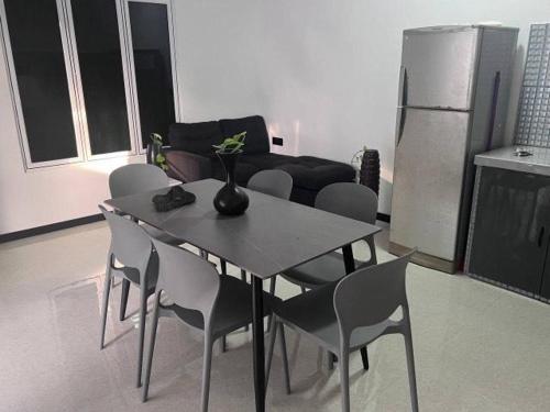 a dining table and chairs in a living room at Lavender Homestay in Thulusdhoo