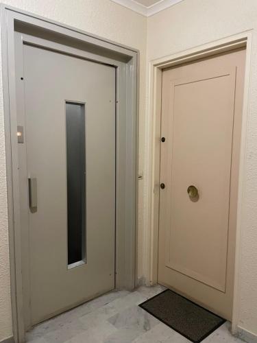 two doors are next to each other in a room at Petit deux pièces avec piscine in Vallauris