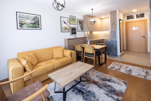 a living room with a couch and a table at Zlatibor Residence & Suites in Zlatibor