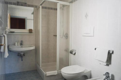 a bathroom with a shower and a toilet and a sink at Belpra in Ortisei