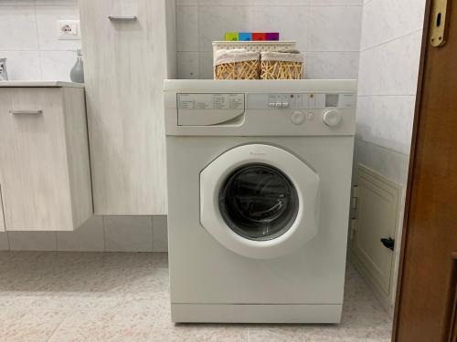 a white washer and dryer in a kitchen at Scarlett 22 - Intero appartamento, centro città, free wifi in Carbonia