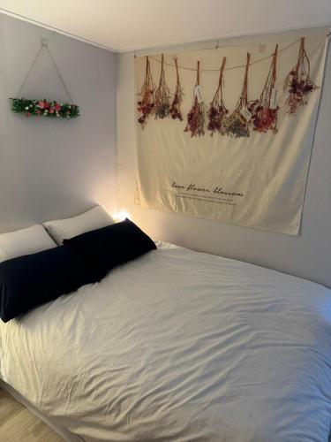 a bedroom with a white bed and a picture on the wall at With US 2 in Seoul