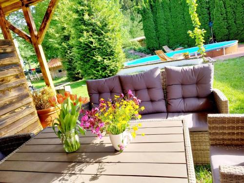 a patio with a couch and flowers on a table at Schernhof in Söll