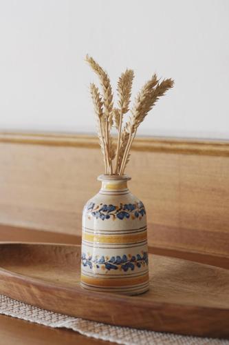 a blue and white vase with a plant in it at Belpra in Ortisei