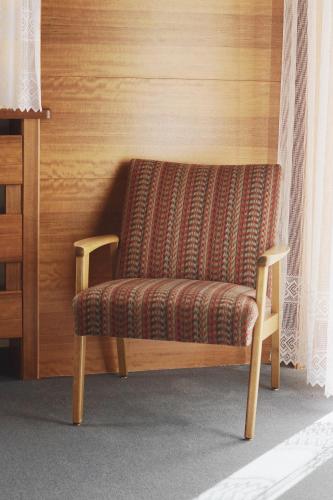 a bench with a patterned seat in a room at Belpra in Ortisei