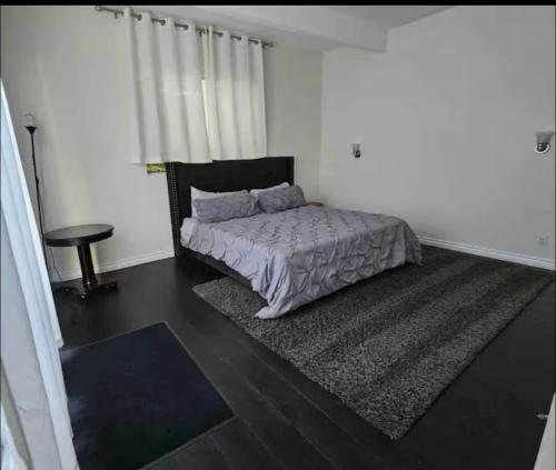 a bedroom with a bed and a table in it at Beautiful 4BD and 3BA Pool Jacuzzi Vacation Home in Los Angeles