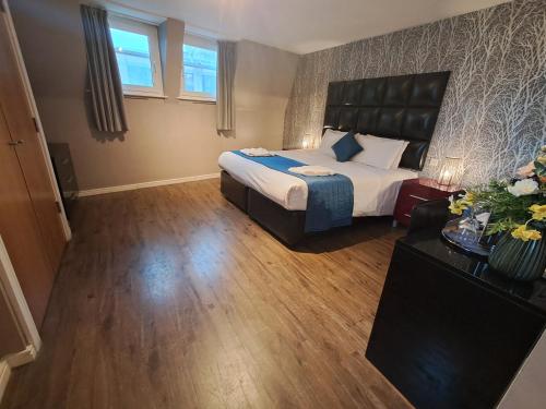 a hotel room with a bed and a couch at The Royal Hotel Cardiff in Cardiff