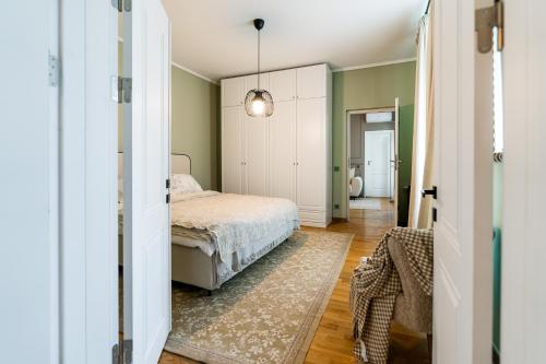 a bedroom with a bed and a hallway at Downtown Calea Victoriei 100 Jacuzzi&Sauna&Bathtub in Bucharest