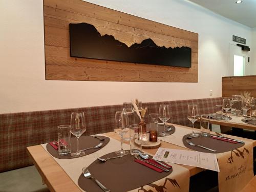 a dining room with two tables with wine glasses at Chalet Sepp in Belalp