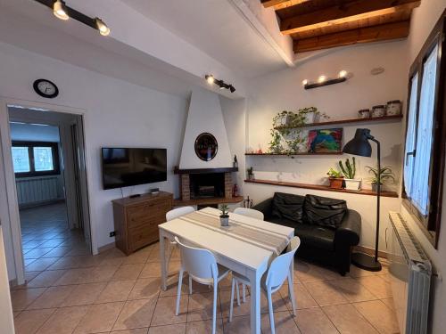 a living room with a table and a couch at La Mansardina in Chioggia