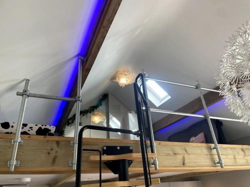 a room with a wooden table and a blue ceiling at Sunset Cottage in Warwick