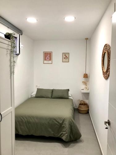a bedroom with a bed in a white room at La Casilla del Molino in Almodóvar del Río