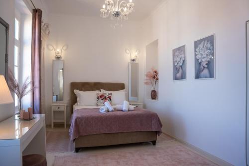 a bedroom with a bed with two teddy bears on it at "Vela" Symi Village Residences in Symi