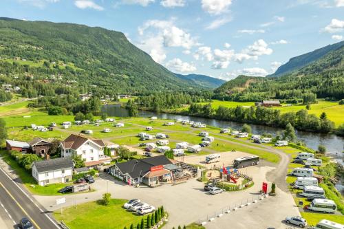 an aerial view of a parking lot next to a river at First Camp Gol Hallingdal in Gol