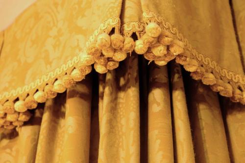 a yellow curtain with grapes on it at H O T E L S A N G A L L O l in Venice