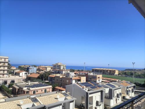 a view of a city with buildings and the ocean at Stefano's house in Siracusa