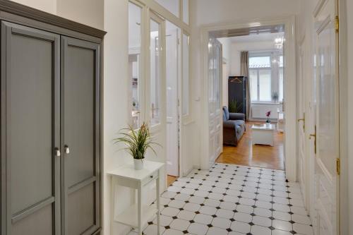 a hallway with a white floor and a room at Charles Bridge Premium Residence in Prague
