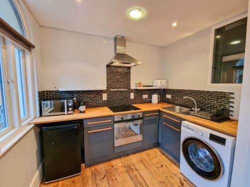 a kitchen with a sink and a dishwasher at City Centre Manchester Apt by City SuperHost in Manchester