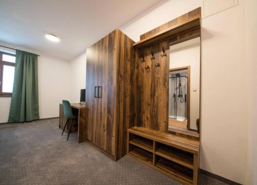 an office with a mirror and a desk in a room at Wellness Hotel Zavadilka in Prostřední Bečva