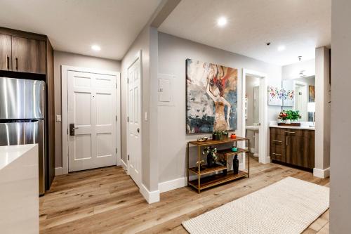 a kitchen with white walls and wooden floors at Treasure Mountain Inn in Park City